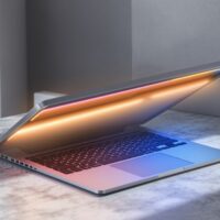 A premium silver laptop with a subtle colored LED strip glowing